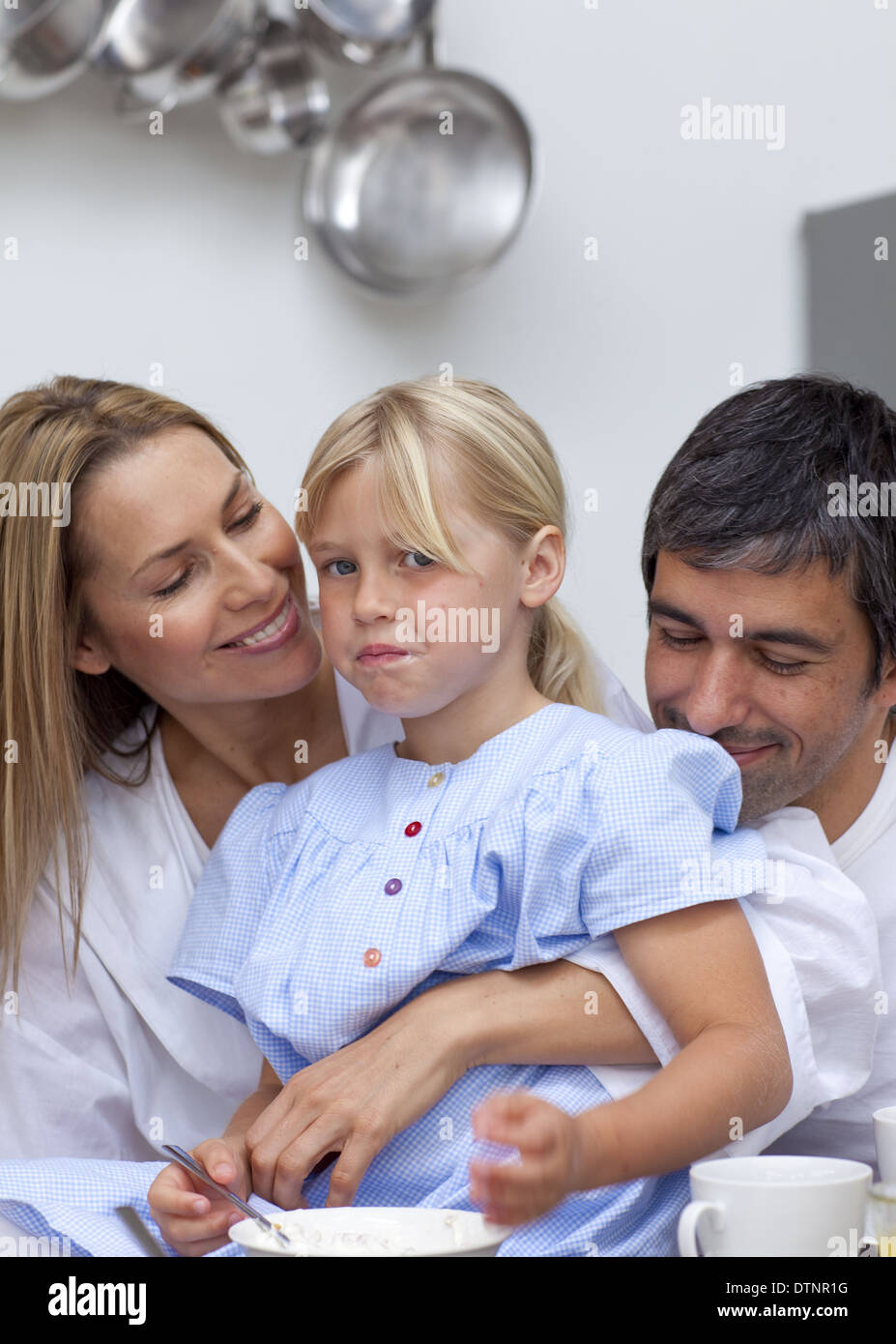 Daughter disliking food with her parents Stock Photo