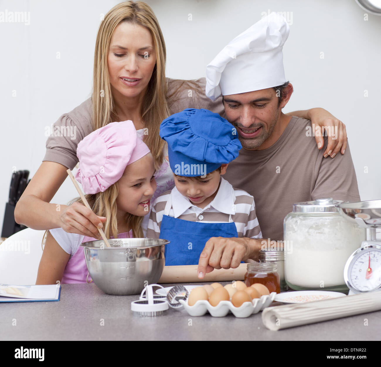 Children baking cookies with their parents Stock Photo