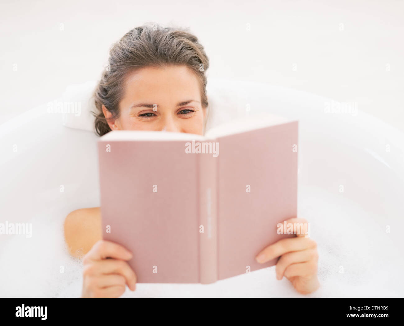 Young woman in bathtub reading book Stock Photo Alamy