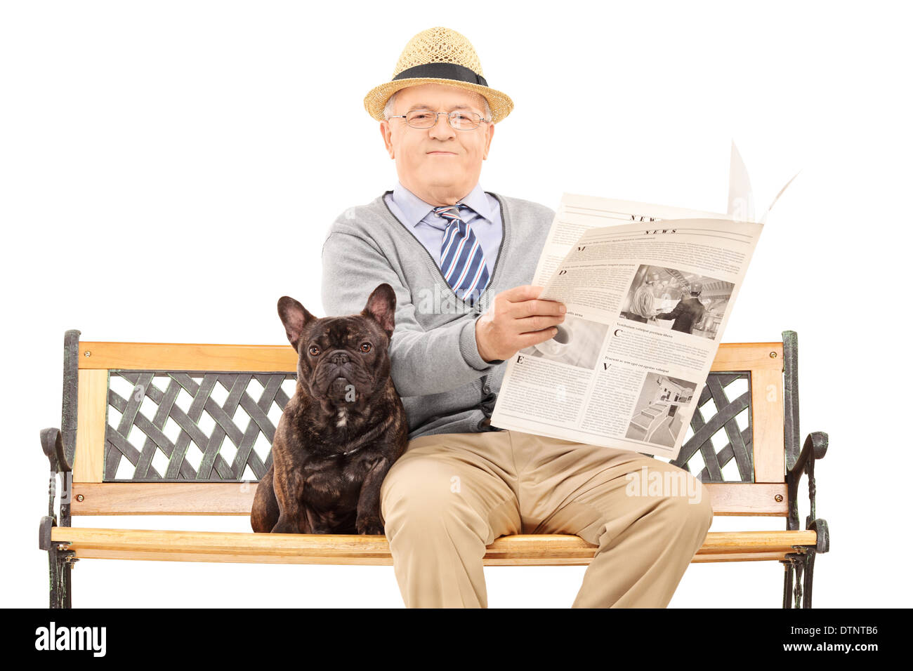 Senior gentleman sitting on a bench with his dog and reading newspaper ...