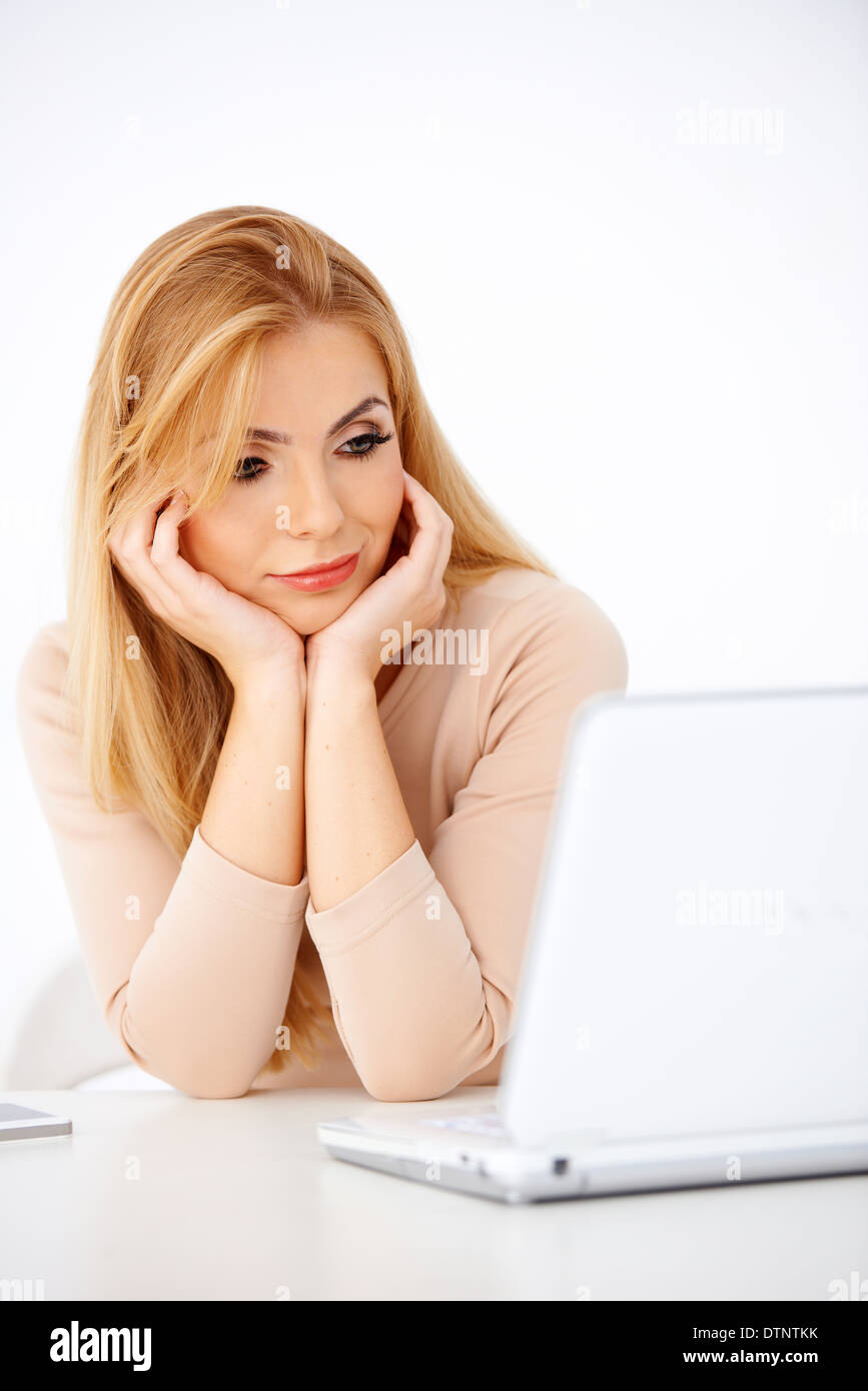 Attractive young blonde woman looking worried Stock Photo