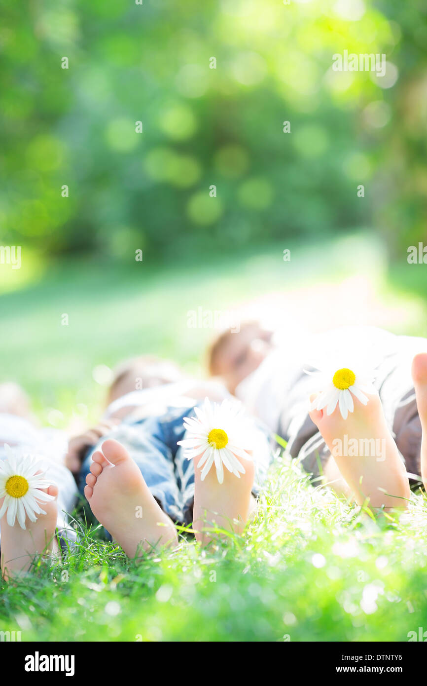 Happy family lying on grass Stock Photo