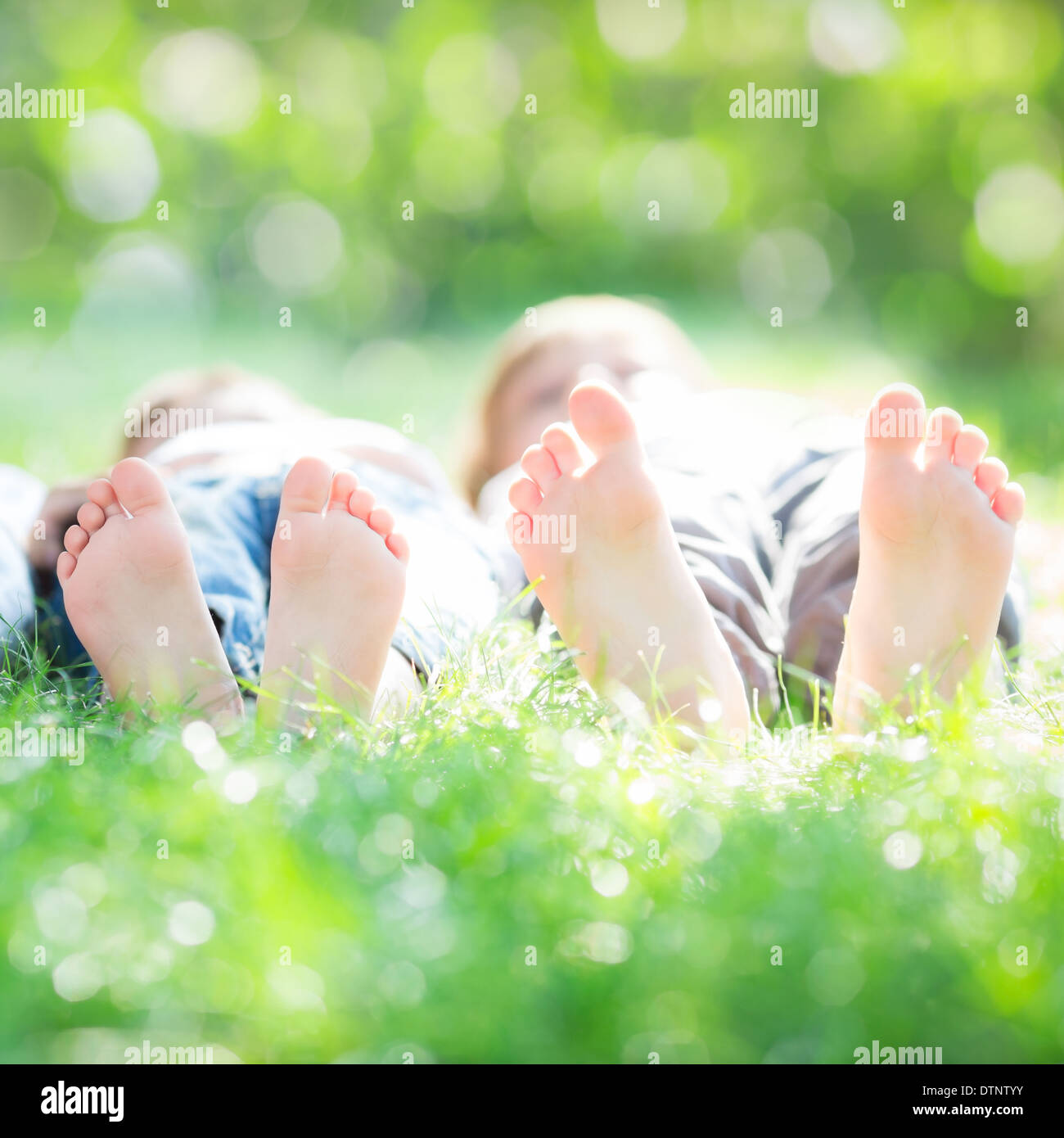 Family lying on grass Stock Photo