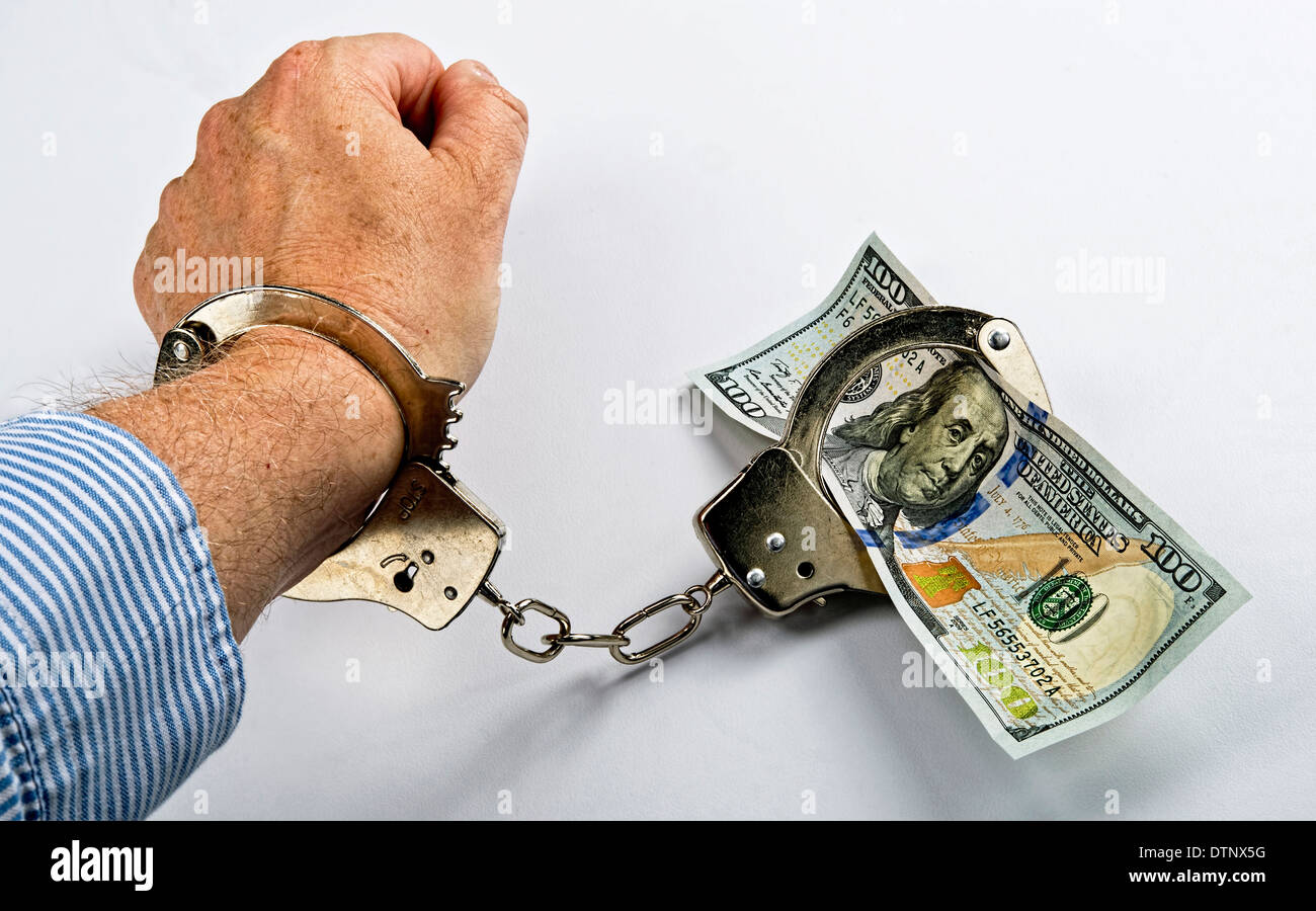 Man made prisoner to cold hard cash. Stock Photo