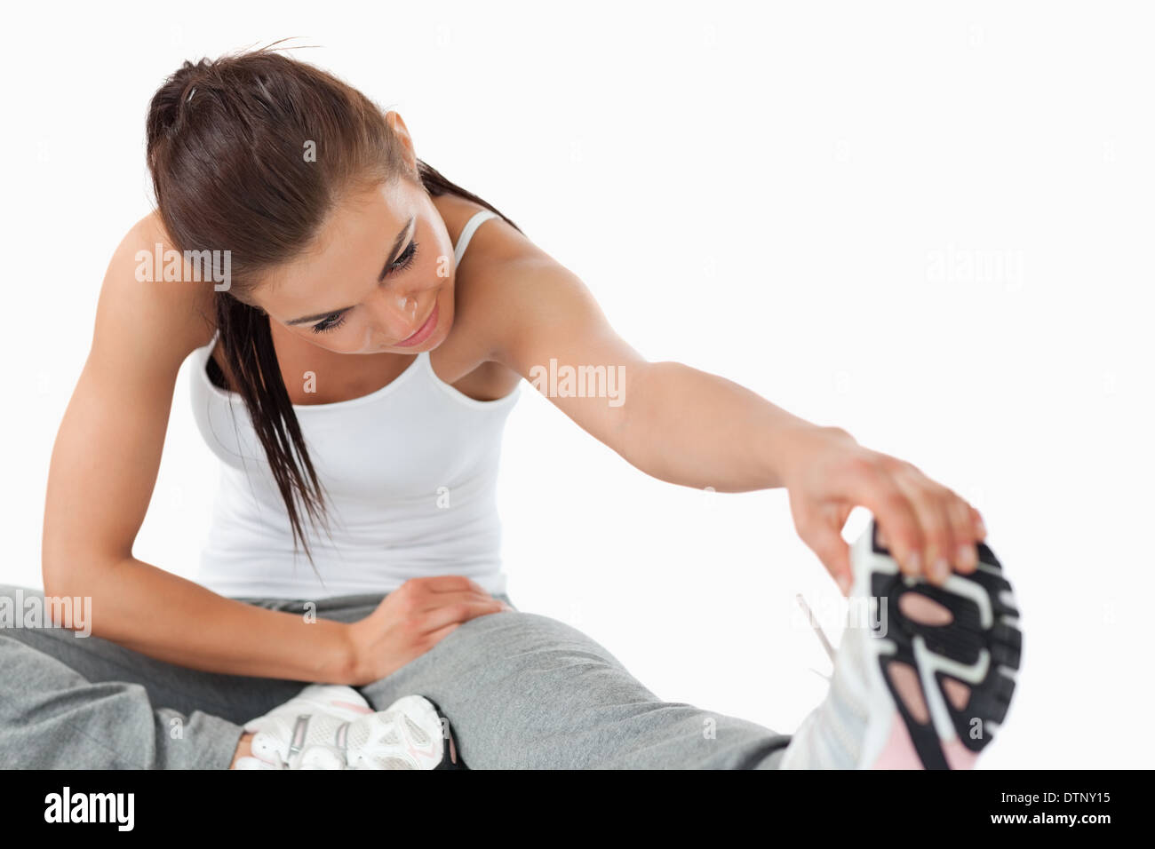 Young woman doing stretches Stock Photo - Alamy