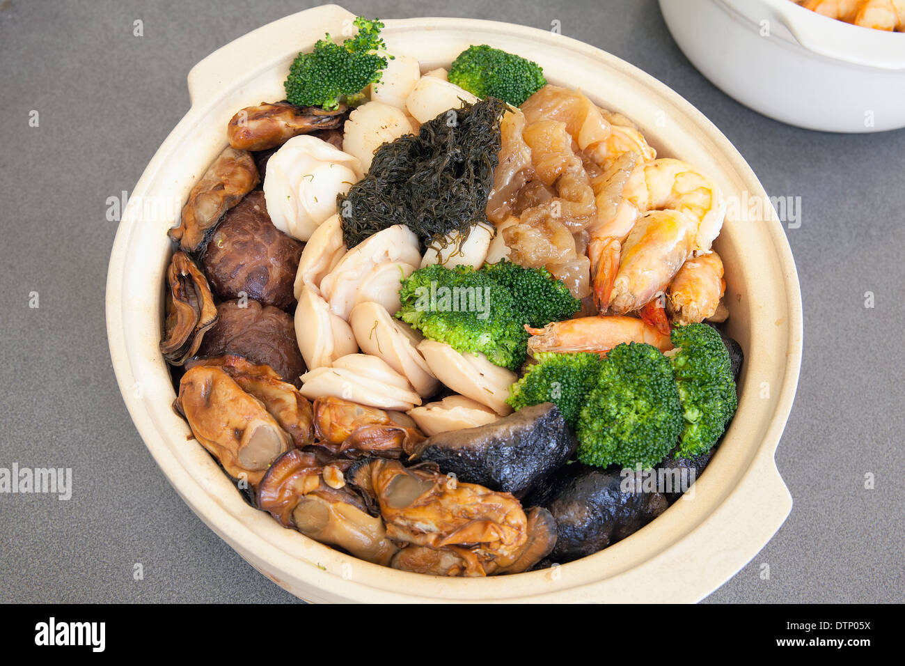 Poon Choi Hong Kong Cantonese Cuisine Big Feast Bowl with Seafood and Vegetables for Chinese New Year Dinner Stock Photo