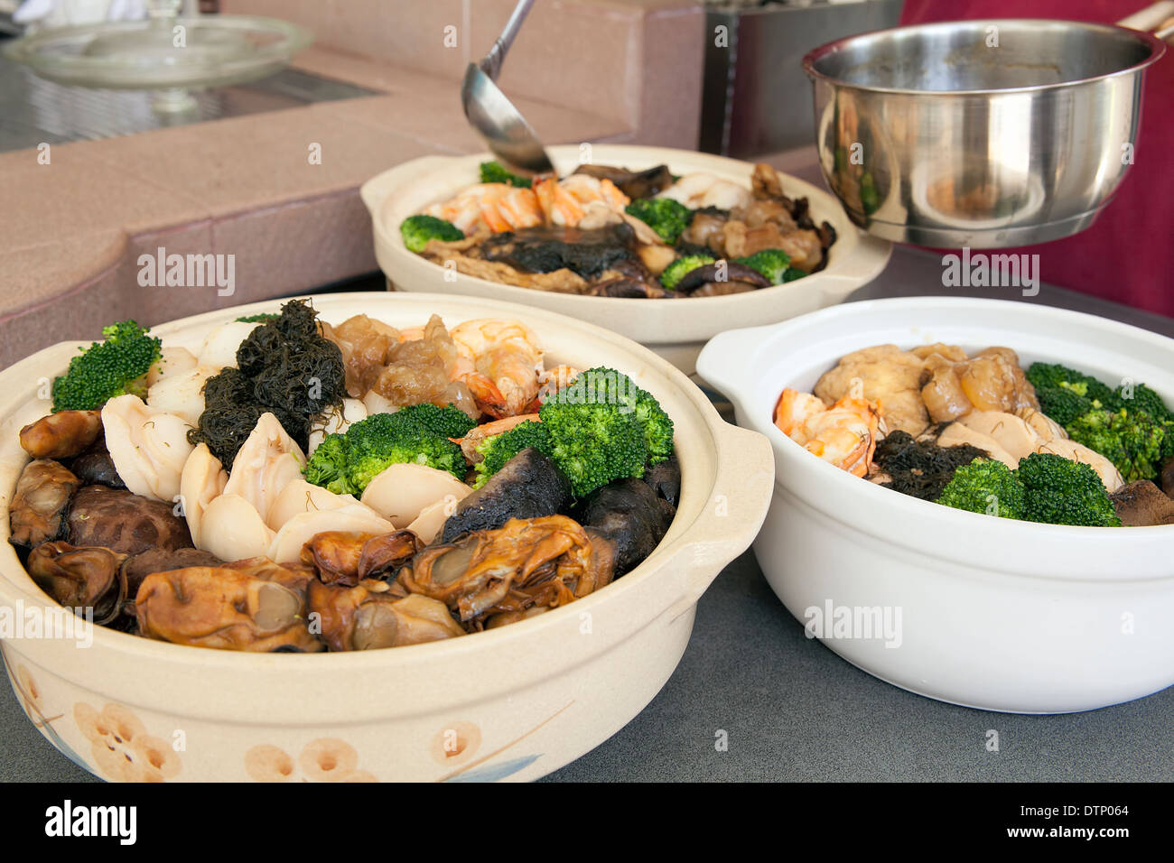 Poon Choi Hong Kong Cantonese Cuisine Big Feast Bowls with Seafood and Vegetables for Chinese New Year Dinner Stock Photo