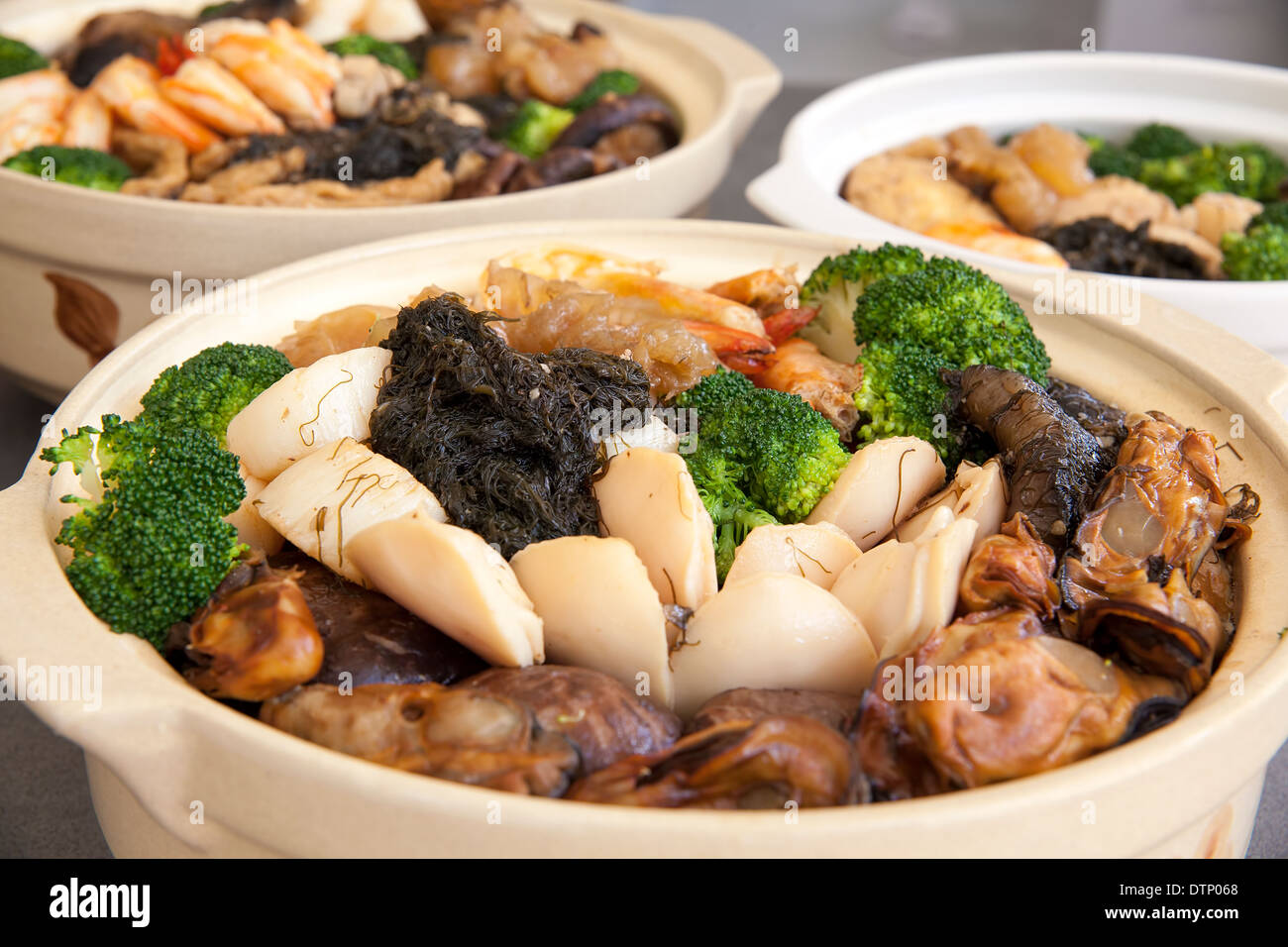Poon Choi Hong Kong Cantonese Cuisine Big Feast Bowls with Seafood and Vegetables for Chinese New Year Dinner Closeup Stock Photo