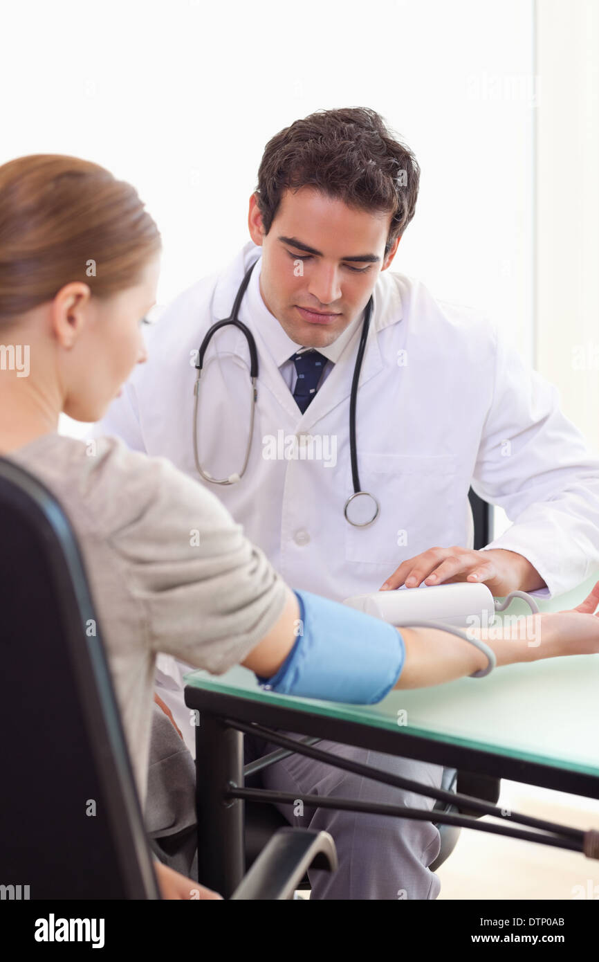 Doctor taking his patients blood pressure Stock Photo Alamy