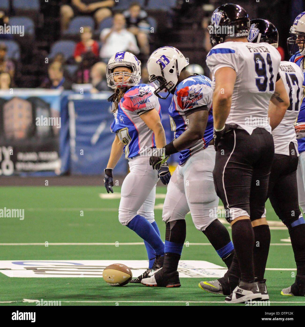 Allen, TX, USA. 21st Feb, 2014. After being tackled late in the fourth quarter, Texas Revolution running back Jennifer Welter (47) looks back at Cedar Rapids Titans' defensive lineman Ben Pister (91) during an Indoor Football League game at the Allen Event Center Friday, February 21, 2014, in Allen, Texas. The 5-foot-2-inch, 130 pound Welter is the first woman to play professional football at a position other than kicker, she made the final roster of the Texas Revolution of the Indoor Football League, as a running back. © csm/Alamy Live News Stock Photo
