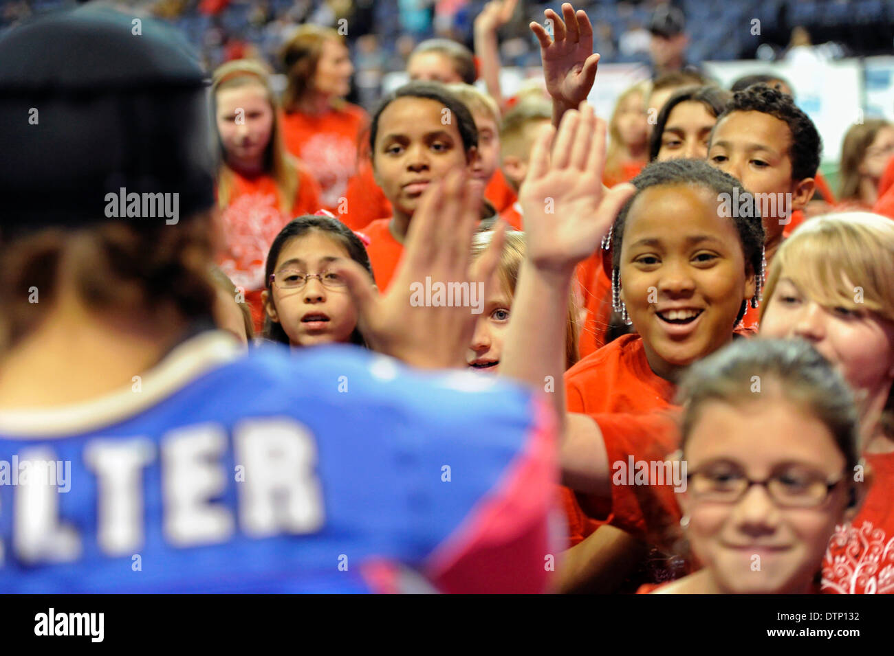 Allen, TX, USA. 21st Feb, 2014. Texas Revolution running back Jennifer Welter high-fives kids as the exit the field prior to the Revolution playing the Cedar Rapids Titans in an Indoor Football League game at the Allen Event Center Friday, February 21, 2014, in Allen, Texas. The 5-foot-2-inch, 130 pound Welter is the first woman to play professional football at a position other than kicker, she made the final roster of the Texas Revolution of the Indoor Football League, as a running back. © csm/Alamy Live News Stock Photo