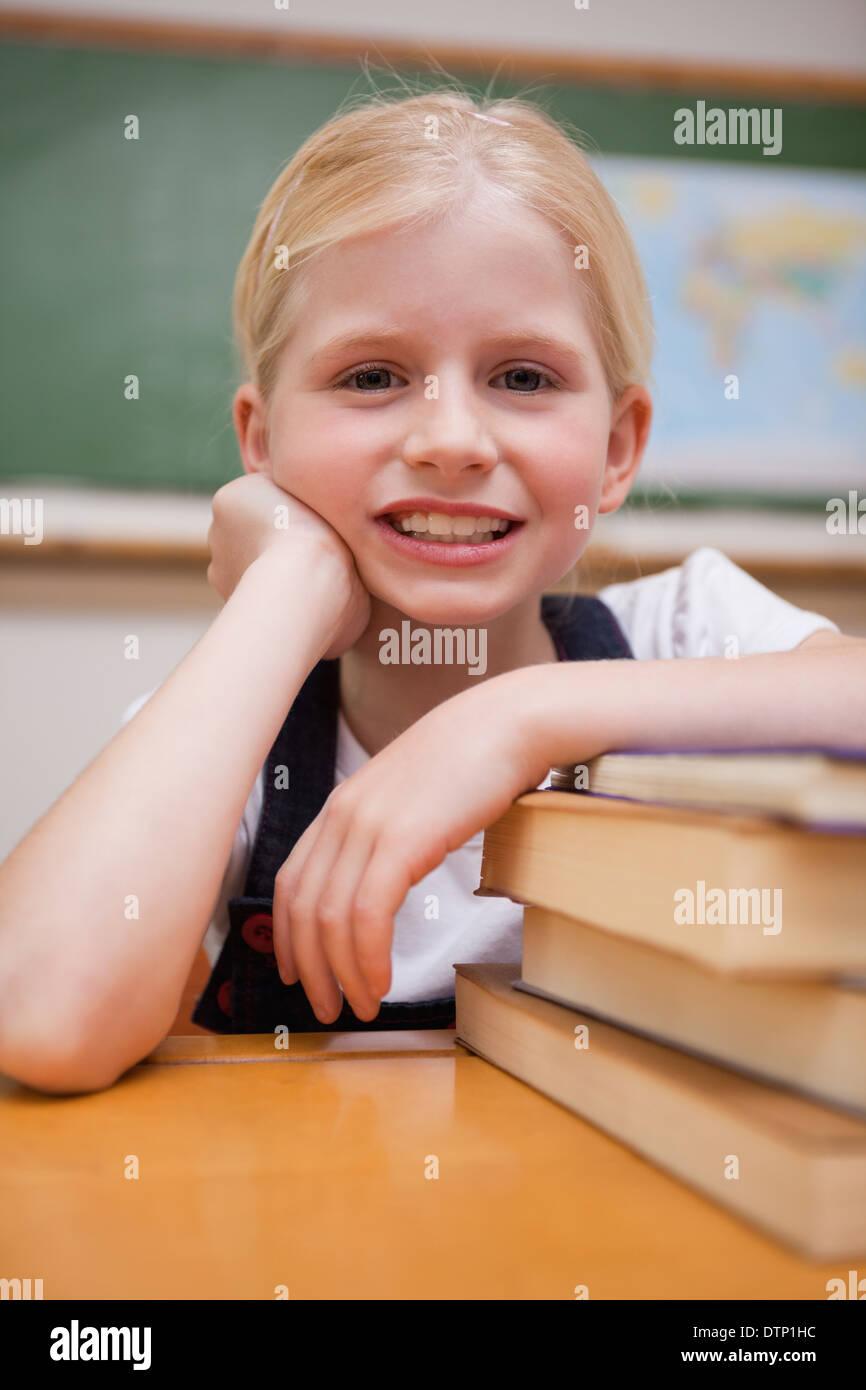 Portrait of a girl leaning on books Stock Photo - Alamy