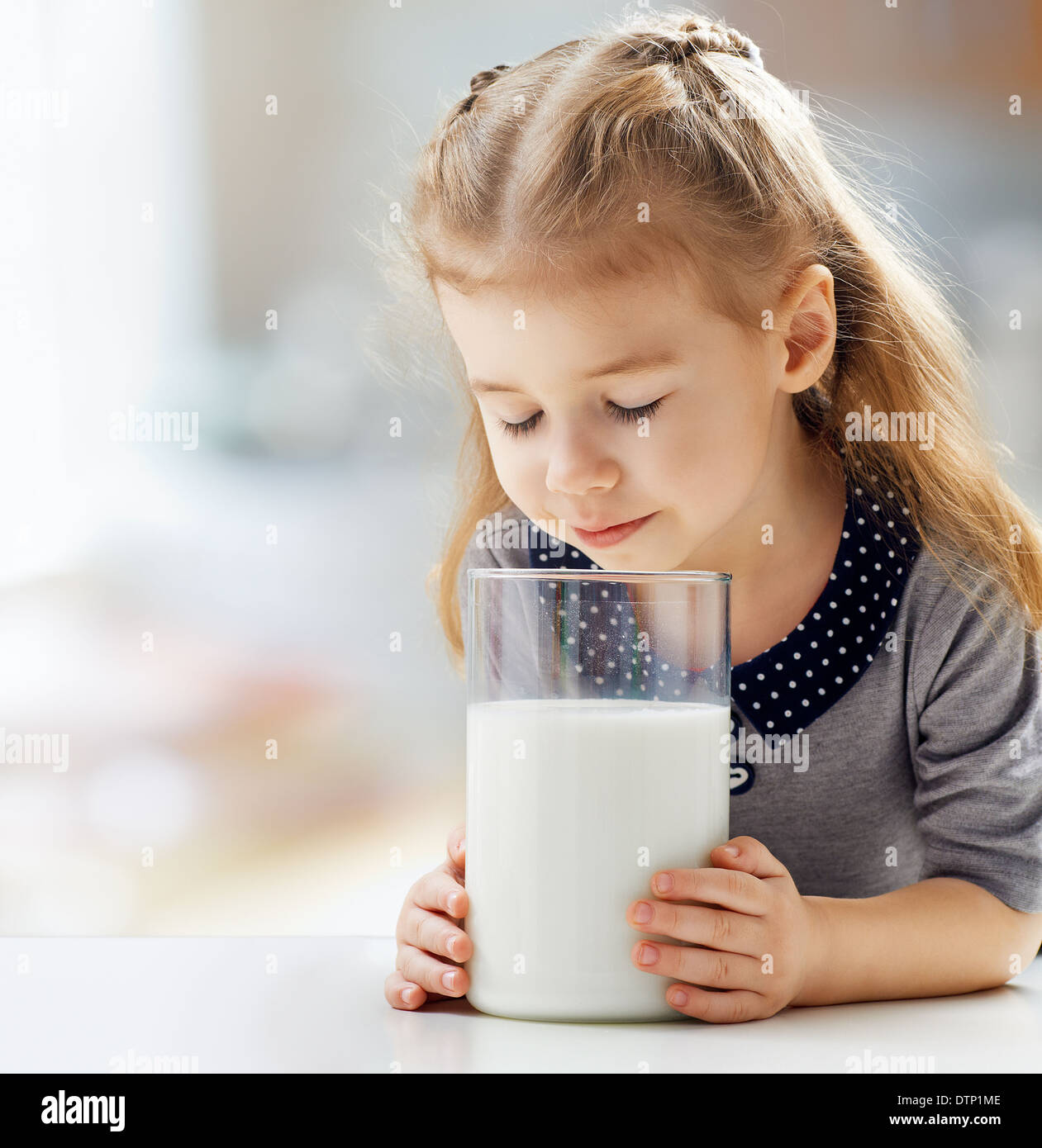 girl drinking milk at the kitchen Stock Photo