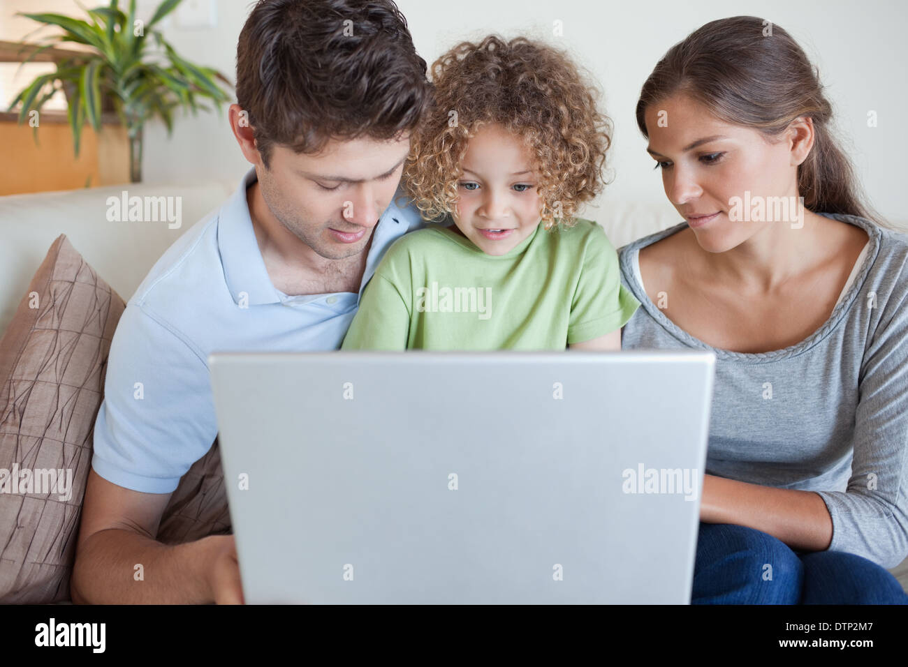 Family using a laptop Stock Photo - Alamy