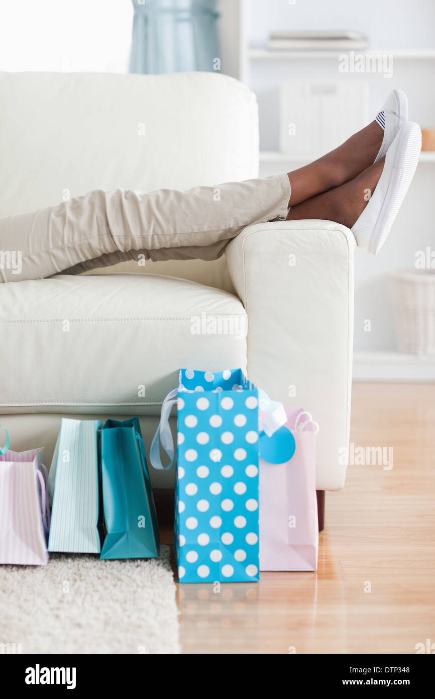 Woman on couch putting her feet up Stock Photo Alamy