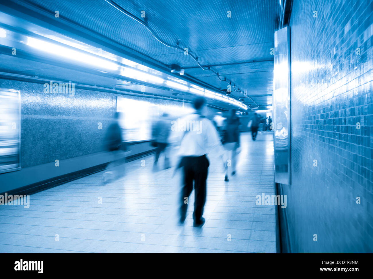 passengers walking in underpass Stock Photo