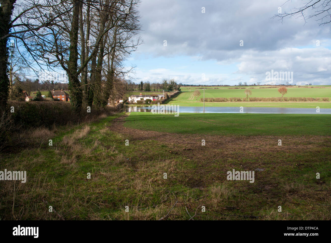 Flood water runs past houses in Deane Stock Photo