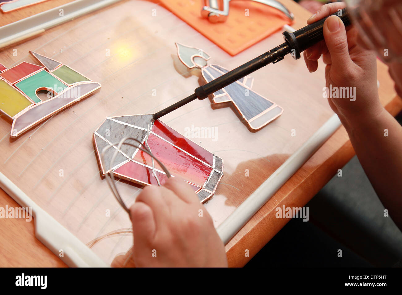 Stained glass maker works with red lamp souvenir Stock Photo Alamy
