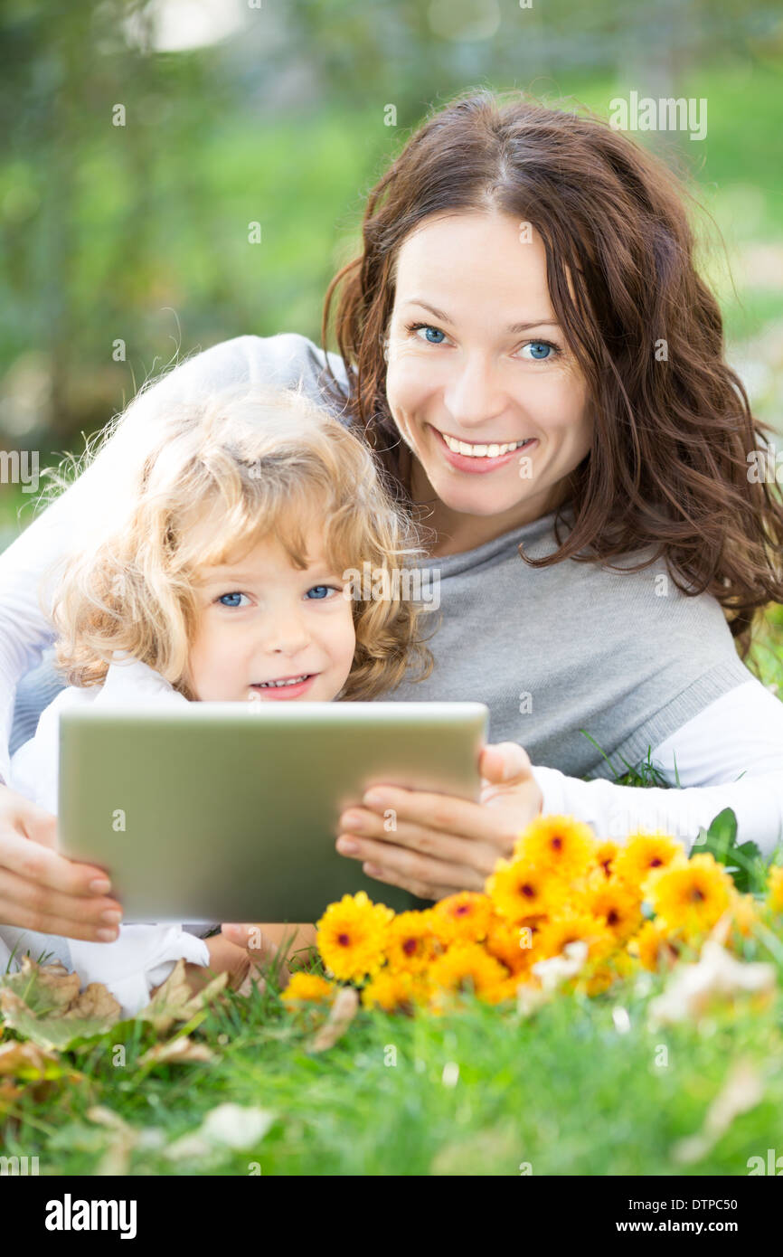 Family using tablet PC outdoors Stock Photo Alamy