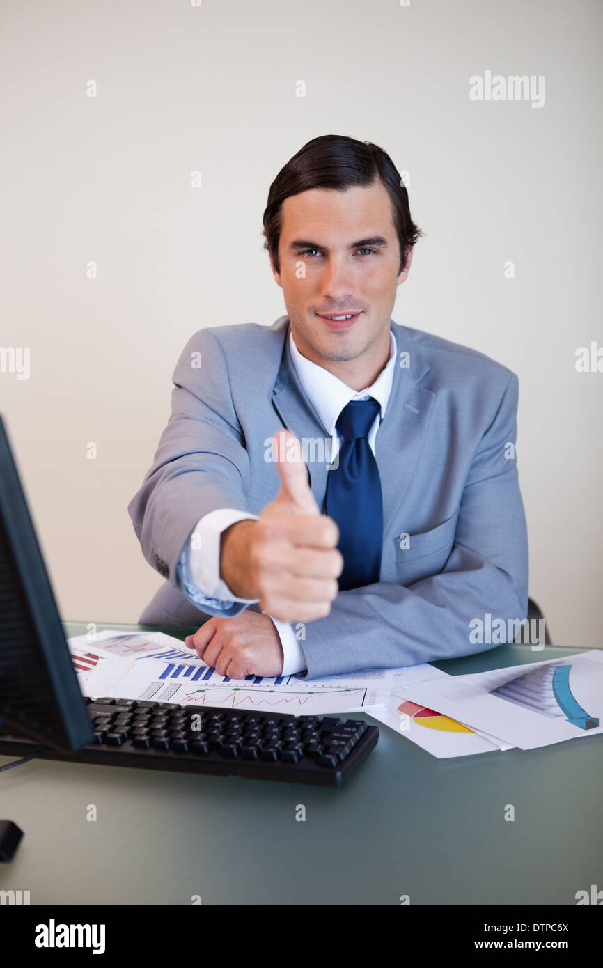 Businessman approves with thumb up Stock Photo