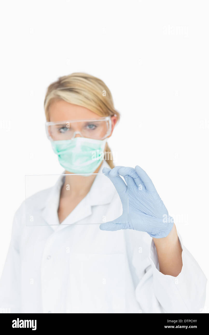 Surgeon looking through clear pane Stock Photo