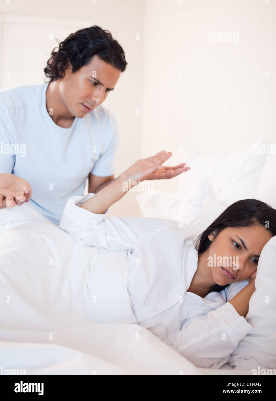 Couple having a dispute in the bed Stock Photo - Alamy