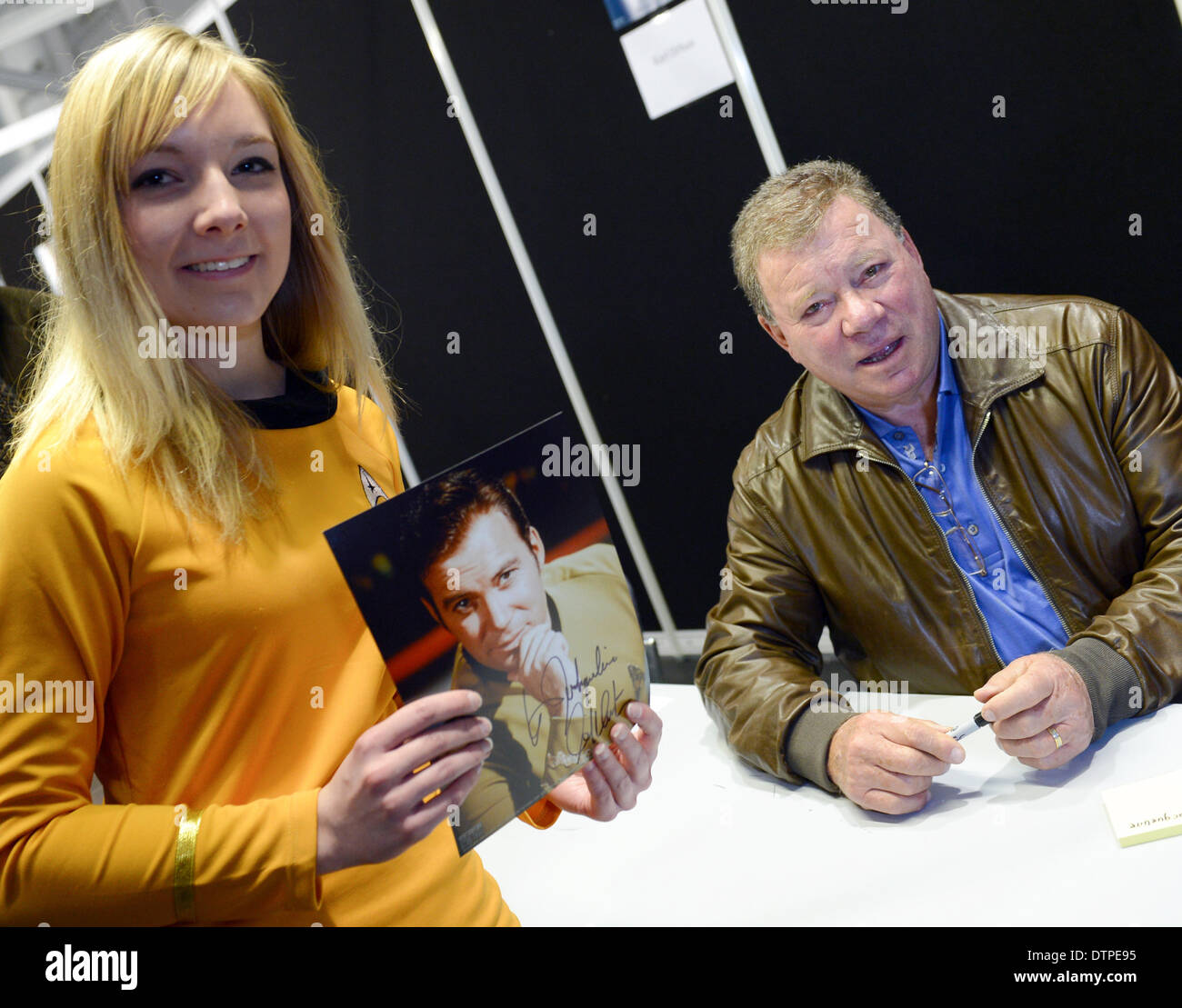 Frankfurt am Main, Germany. 22nd Feb, 2014. Star Trek fan Jacqueline Jardine receives an autograph from William Shatner who played James T. Kirk in the tlevision series Star Trek during a Star Trek meeting at the convention center in Frankfurt am Main, Germany, 22 February 2014. Thousands of Star Trek fans are expected for the 'Destination Star Trek' event, which takes takes place in Germany for the first time. Photo: ARNE DEDERT/dpa/Alamy Live News Stock Photo