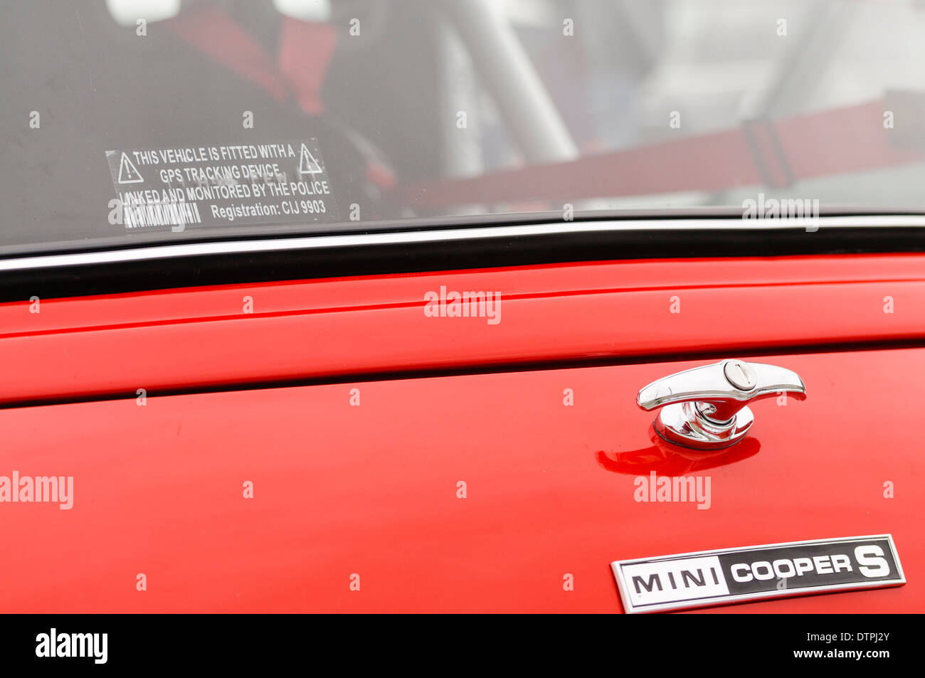 Mini Cooper S with a warning that a GPS tracker is fitted to prevent theft. Stock Photo