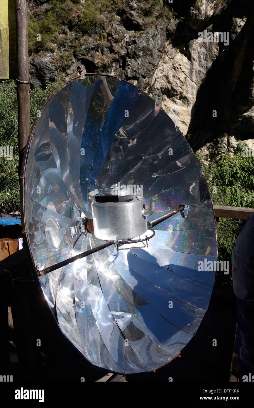 Heating a kettle of water on a solar cooker at a restaurant in the Manaslu region in Nepal. Stock Photo