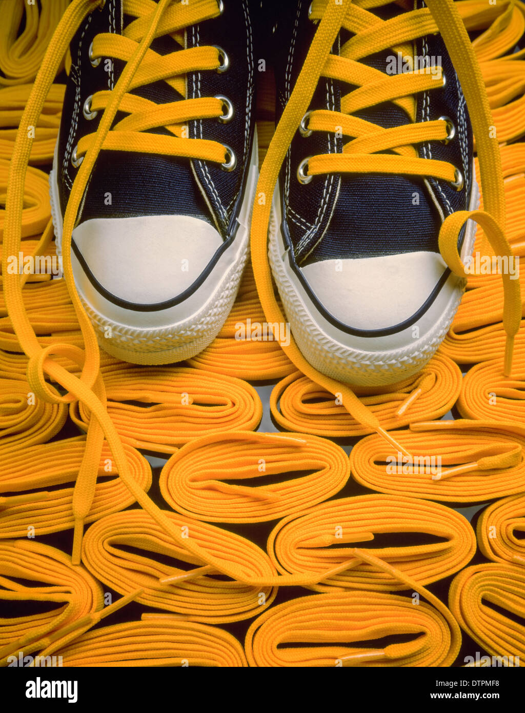 Yellow shoe laces with blue Converse "Chuck Taylor" sneakers Stock Photo -  Alamy