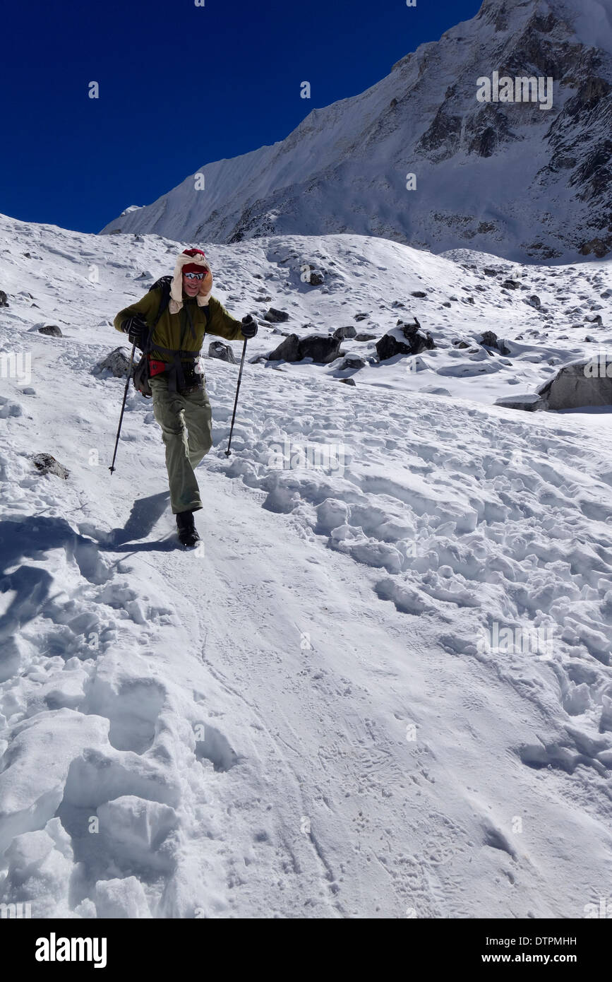 Trekker glassading down from Larkya La (Larkya Pass) in the Manaslu region of Nepal. Stock Photo