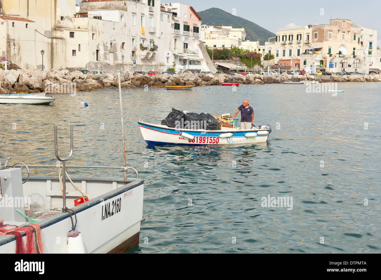 Boat with dustman waste disposal on the Ischia island. Stock Photo