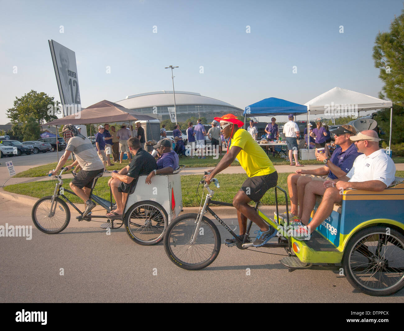 Getting around sports fans ride in pedicab from the tailgate BBQ to the stadium Stock Photo
