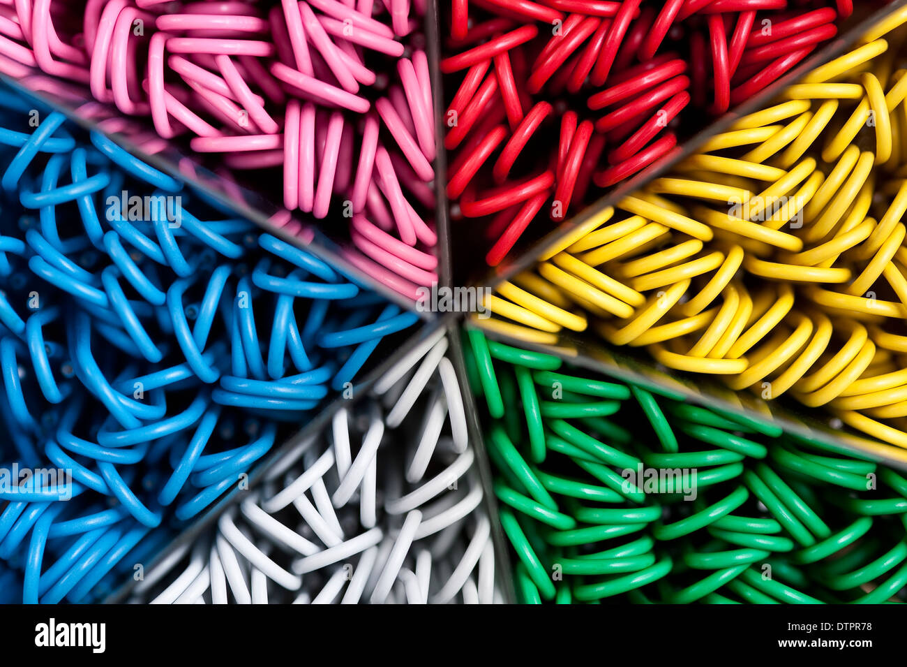 Container of multicolored paper clips Stock Photo