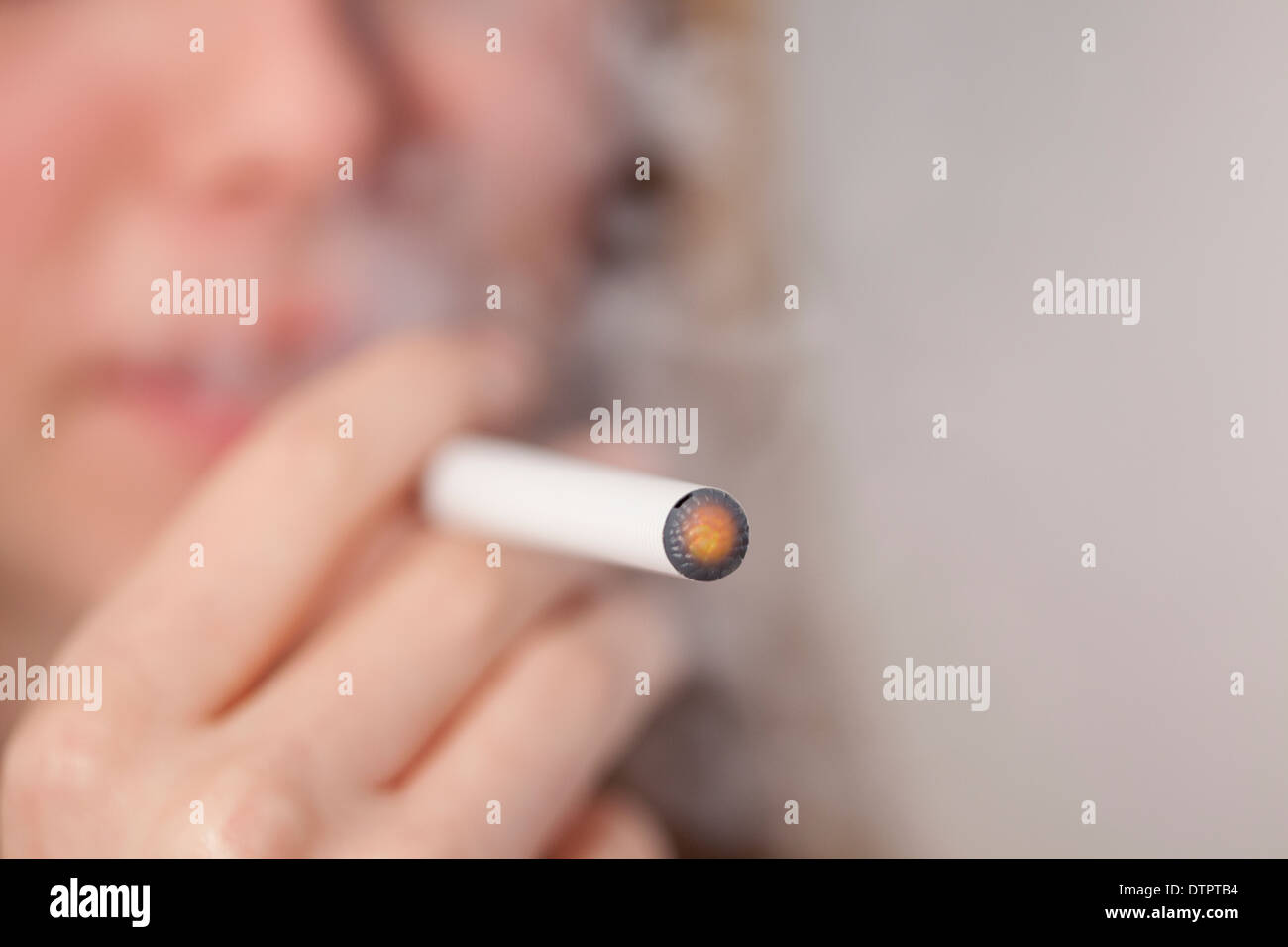 Young teenage girl smoking e or electronic cigarette, image is anonymous Stock Photo