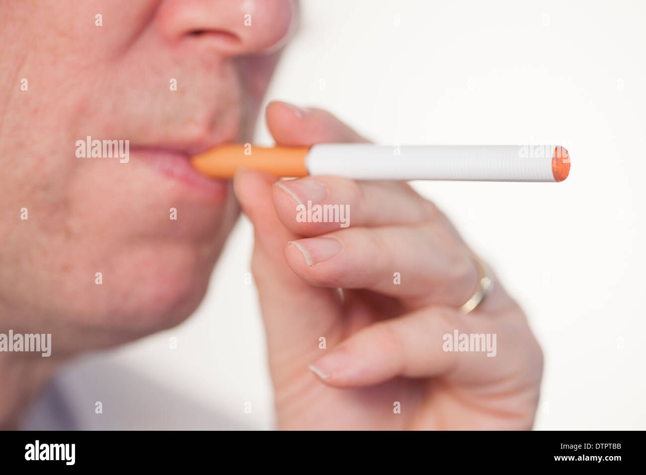 smoking or vaping an E or electronic cigarette Stock Photo