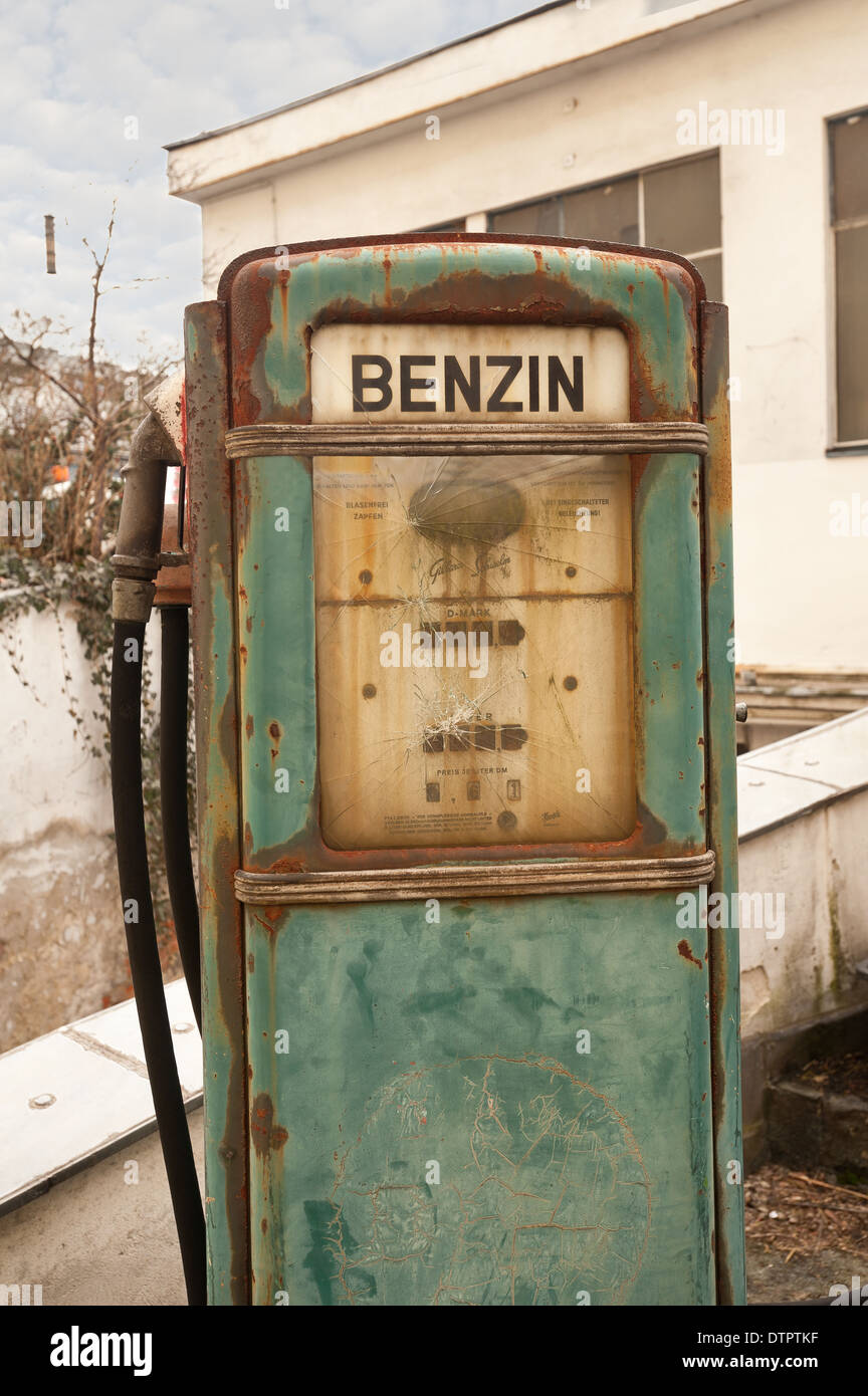Old fashioned petrol diesel benzine fuel pump dispenser retro design left abandoned on old disused garage forecourt Stock Photo