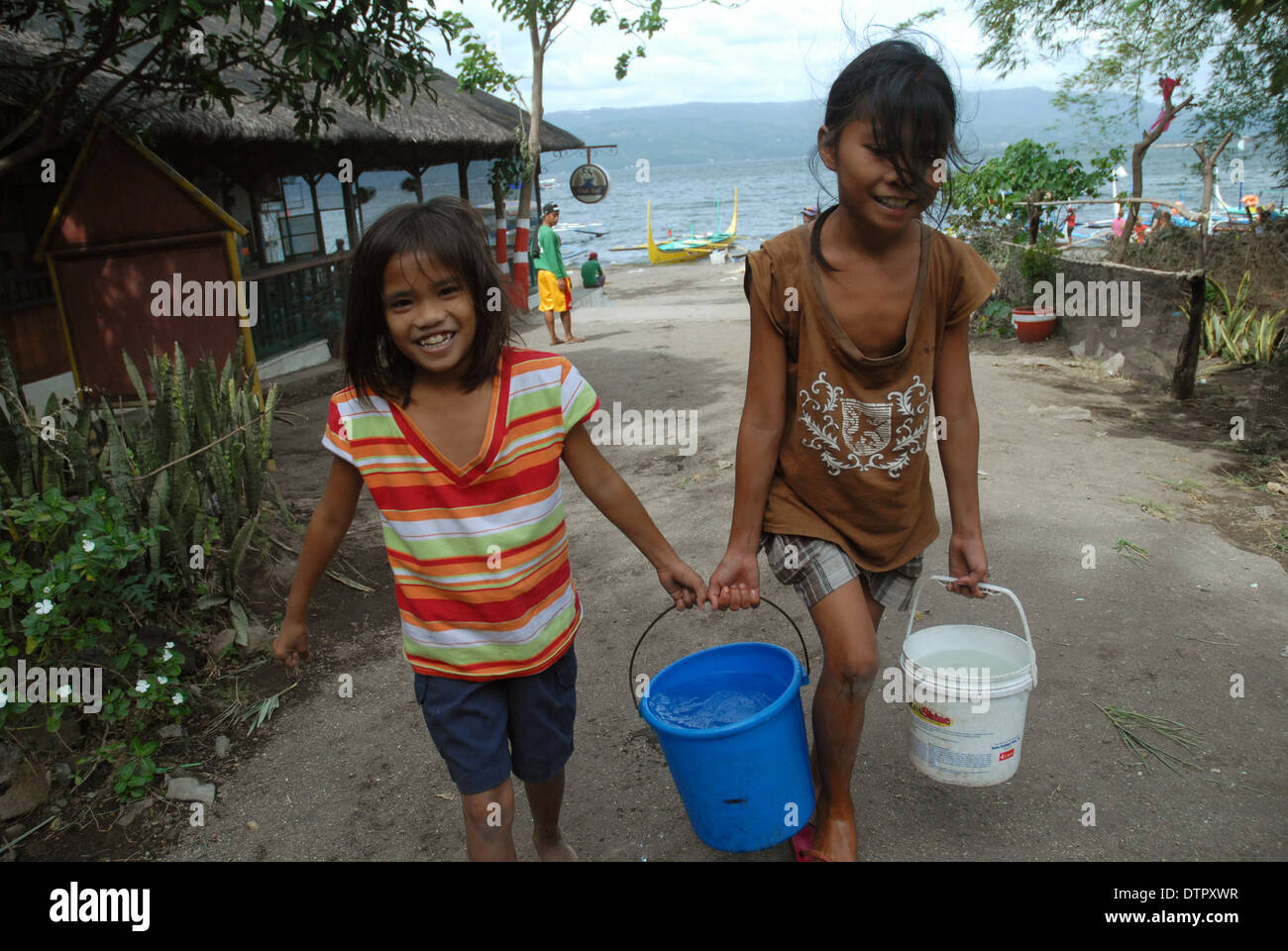 Girls carrying water, Taal Volcano, Luzon, Philippines, Asia Stock