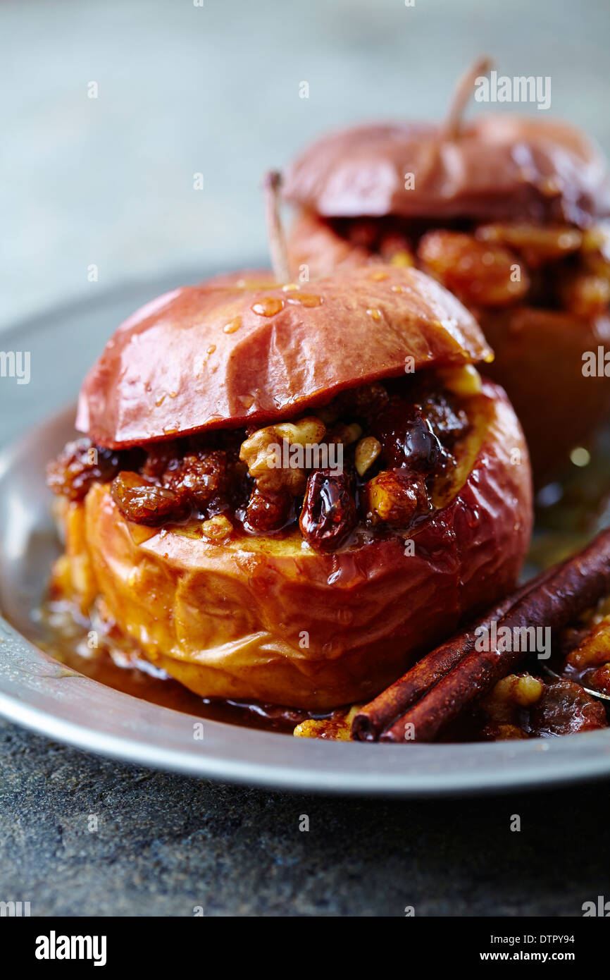 baked apple stuffed with walnuts, brown sugar and raisins Stock Photo