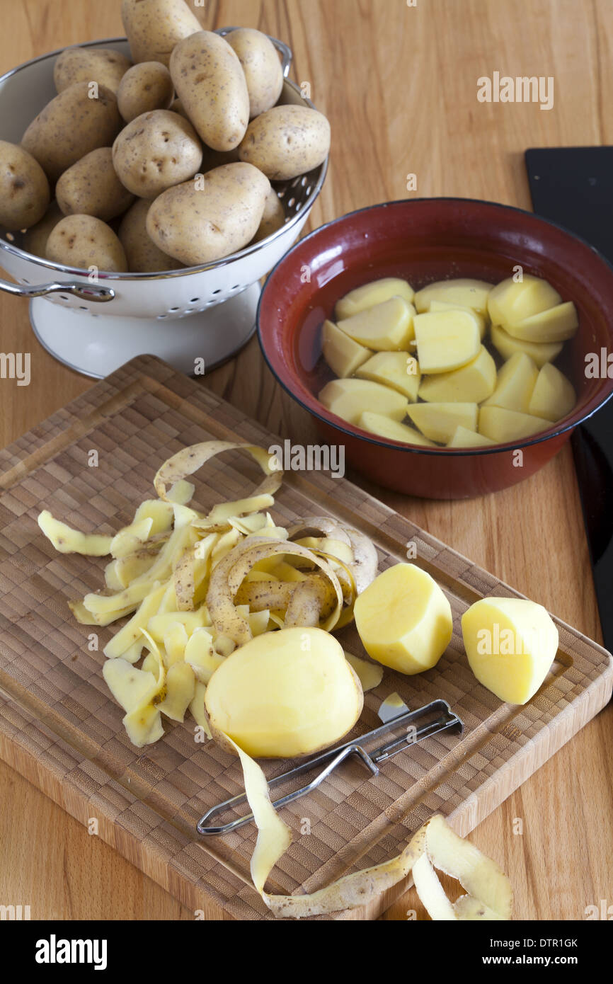 Raw potatoes and kitchen utensils on the Worktop Stock Photo Alamy