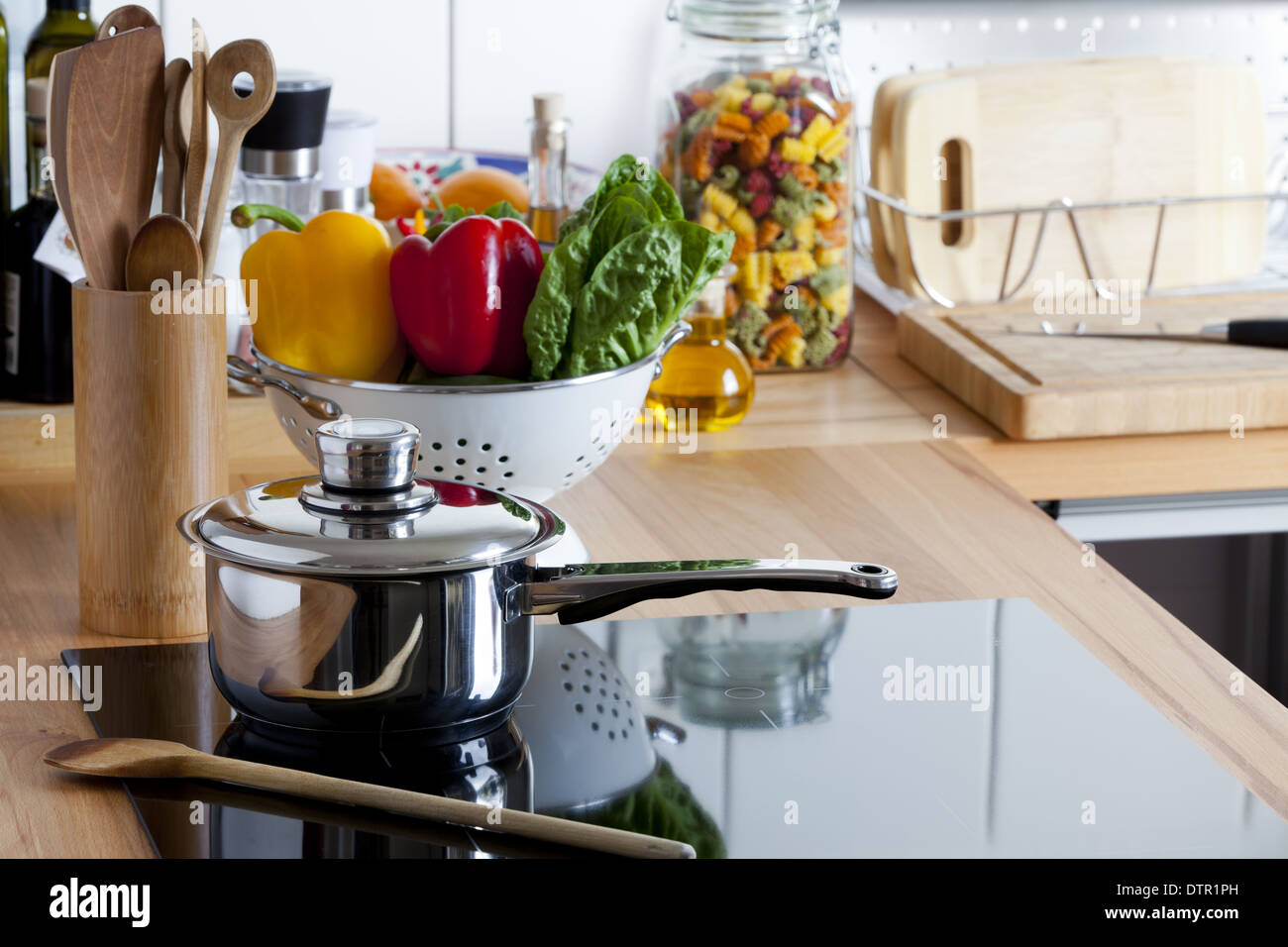 Cooking Pot and Wooden Spoon on Ceramic Hob with Copy Space in right