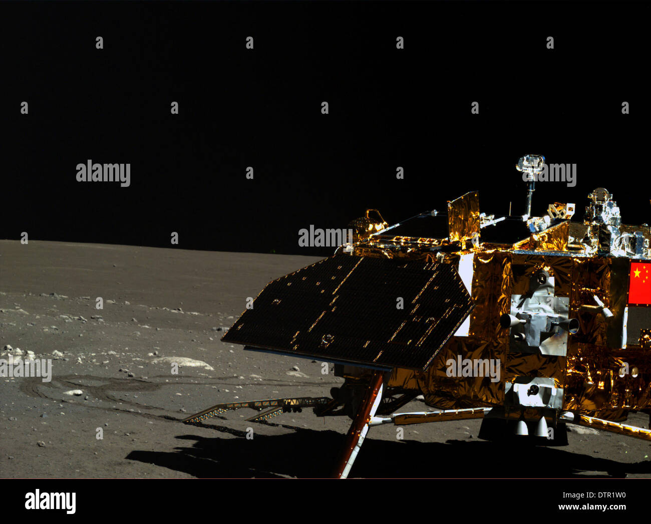 Beijing, China. 23rd Feb, 2014. This undated photo taken by the camera on the Yutu moon rover shows the Chang'e-3 moon lander and the moon surface. The Chang'e-3 lander entered its third dormancy on early Feb. 23, 2014. China's lunar rover Yutu also entered the dormancy on Feb. 22, with the mechanical control issues that might cripple the vehicle still unresolved. Credit:  Xinhua/Alamy Live News Stock Photo