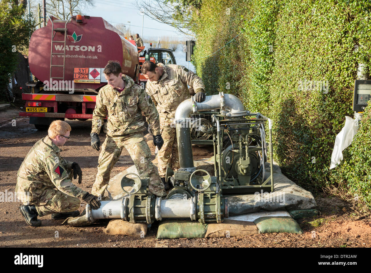 Burrowbridge, UK. 22nd Feb, 2014. A new pump flown in by Merlin helicopter is being made operational by Army Commandos at Burrowbridge on February 22, 2014. The pump will supply Saltmoor Pumping Station, run by the Environment Agency, with diesel fuel for its addiitional water pumps that have been installed to remove the high volume of flood water from the surrounding fields around Northmoor and village of Moorland and pump it into the River Parrett where it is carried away by the tide. This is the worst flooding on the Somerset Levels in living history. Stock Photo