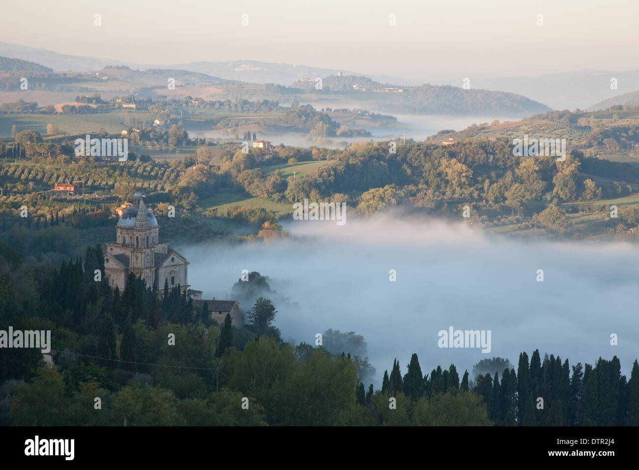 Morning mist and sunlight on San Biagio and the slopes below Montepulciano, Tuscany, Italy. Mandatory credit Jo Whitworth Stock Photo