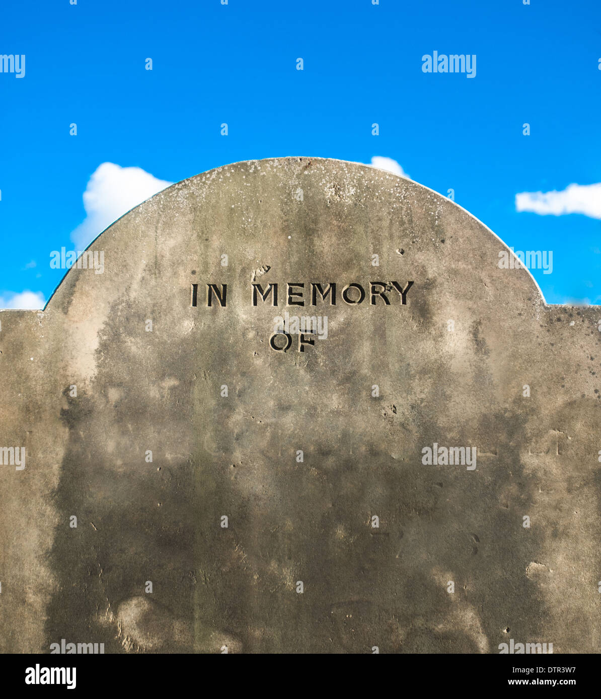 Old weathered grave with "In Memory Of" and name left blank. Stock Photo