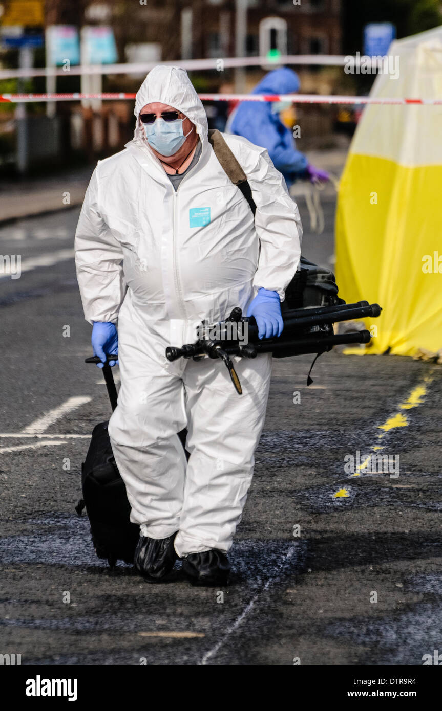 Belfast, Northern Ireland, 23rd February 2014 - A Scene of Crime Officer leaves a crime scene carrying photographic equipment Credit:  Stephen Barnes/Alamy Live News Stock Photo