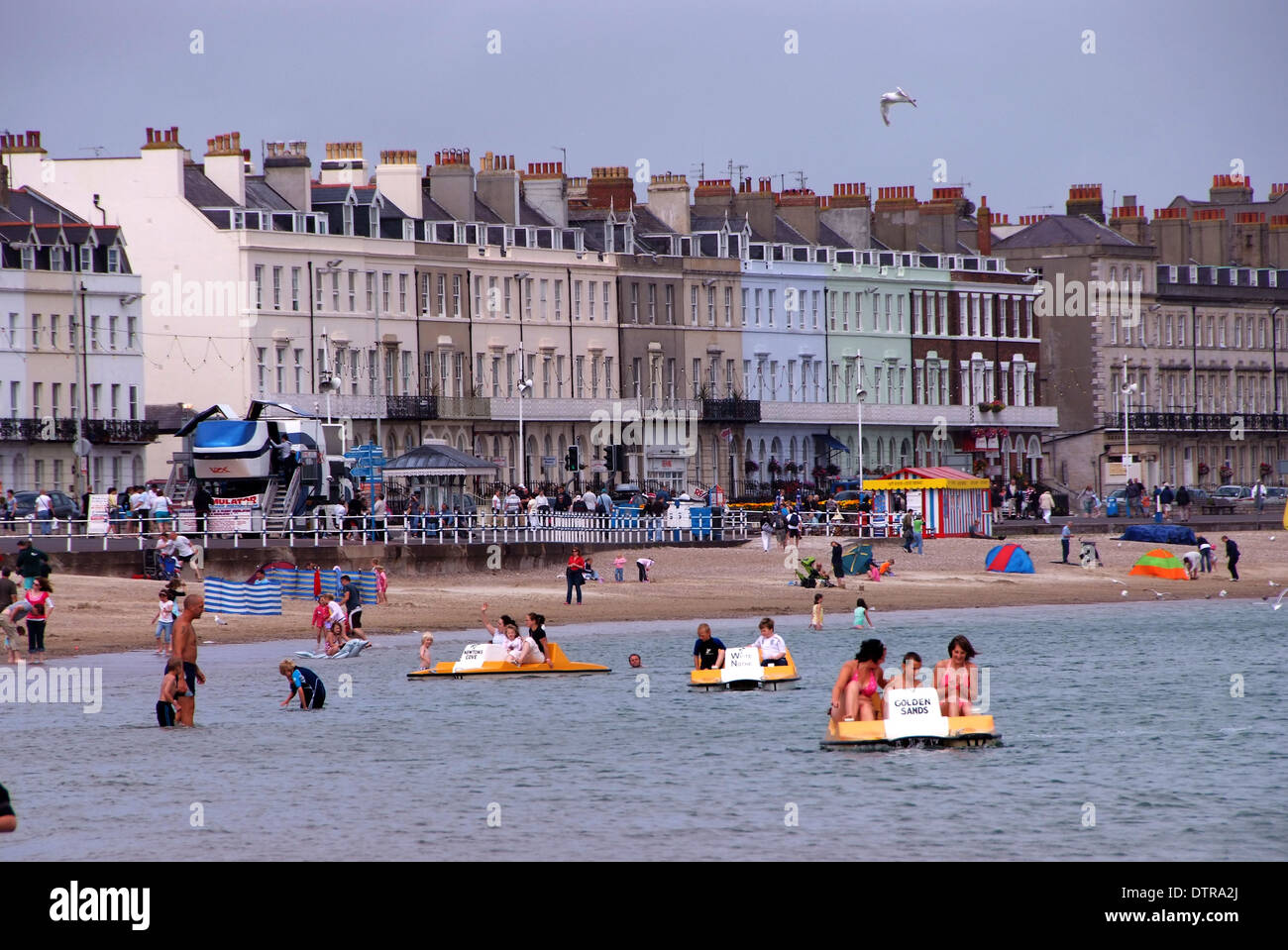 Weymouth in Dorset, showing the beach, the marina, harbour, statue of the Prince Regent, promenade and a Punch & Judy show. Stock Photo