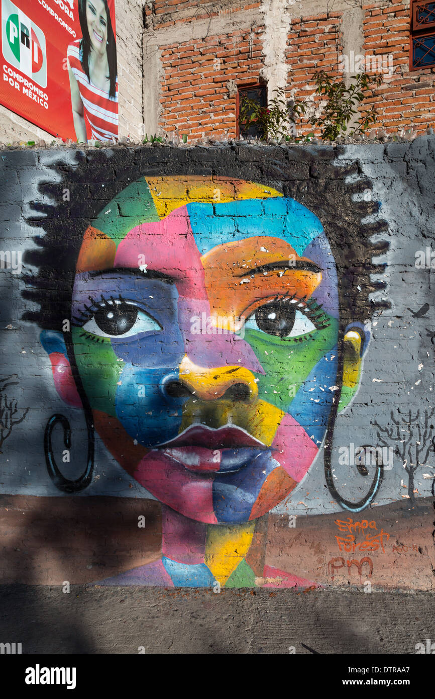 Street art depicting a multi colorful woman along a street in Santiago ...