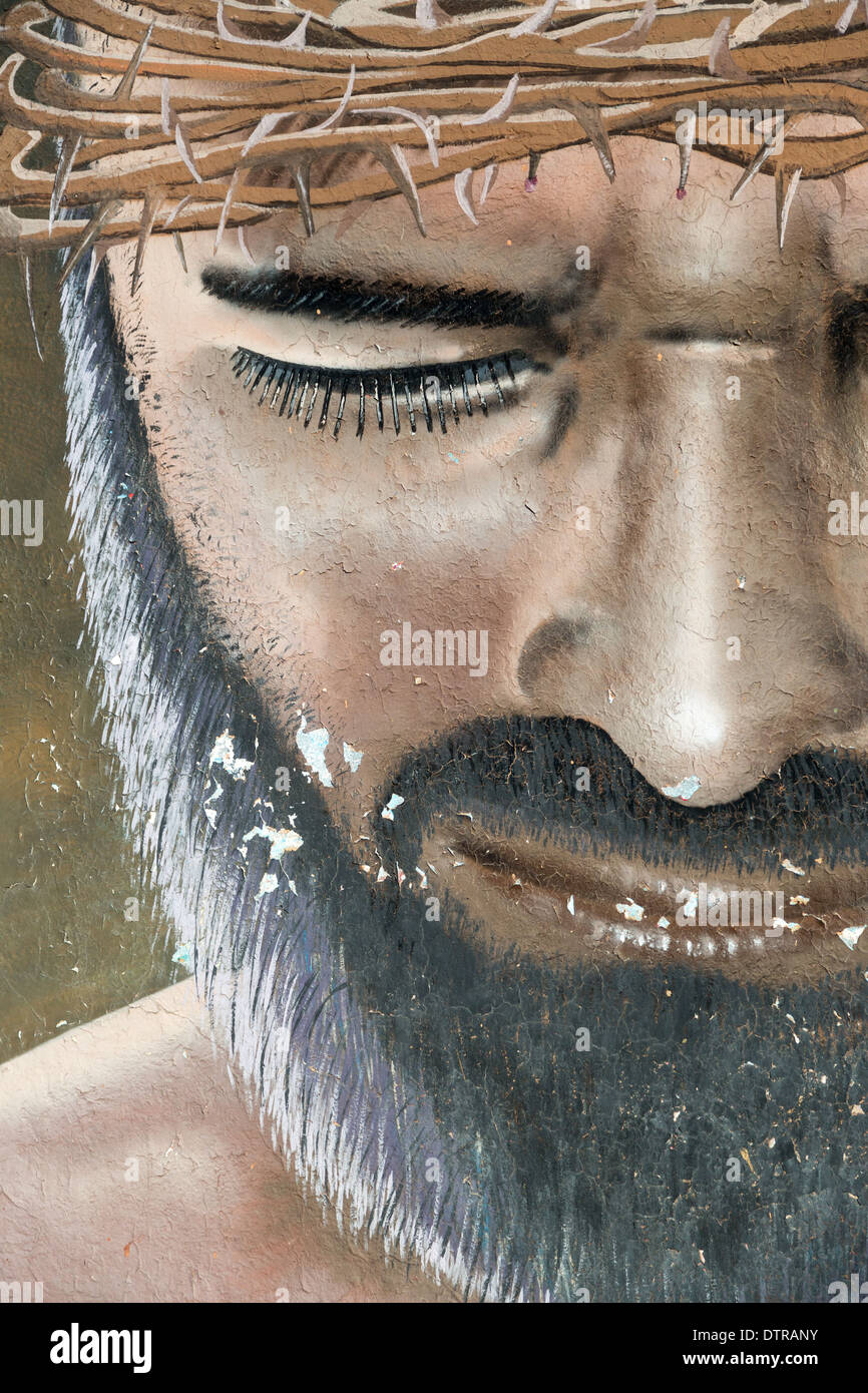 Street art depicting Jesus Christ with a crown of thorns along a street