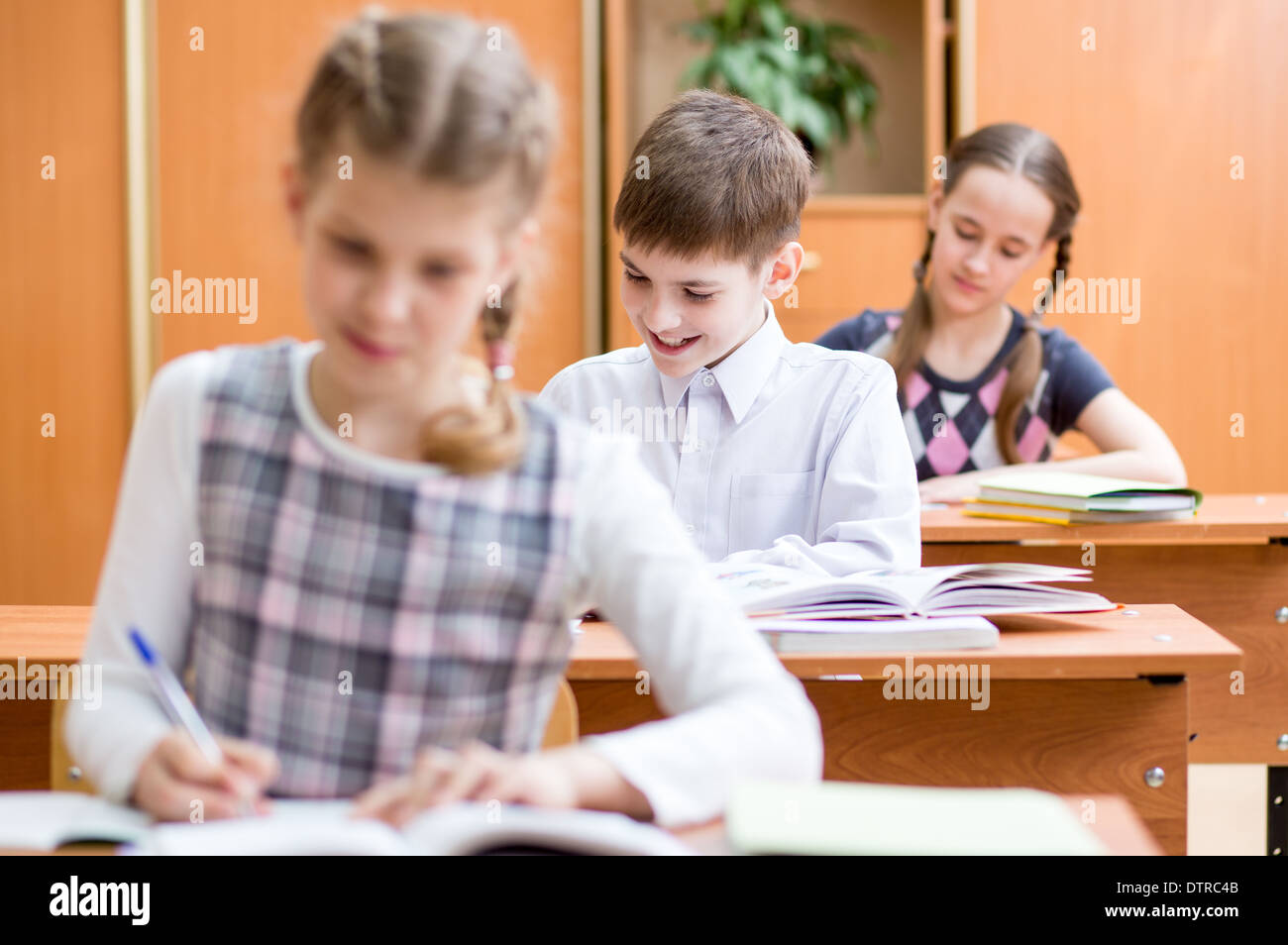 school kids work at lesson in classroom Stock Photo
